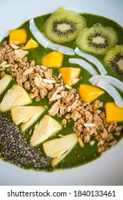 Smoothie Bowl With Kiwi, Coconut, Mango, Pinapple, Granola And Chia Seeds With Green Yogurt