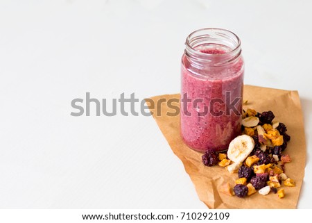 Similar – Mann hält einen Milchshake aus Beeren und Haferflocken.