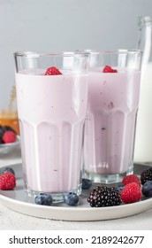 Smoothie From Fresh Berries, Natural Yogurt And Honey In Two Tall Glasses On Gray Background, Vertical Format