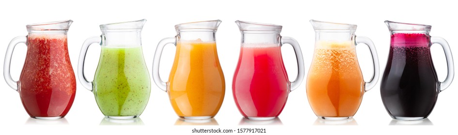 Smoothies or freshly pressed juices in glass pitchers, isolated