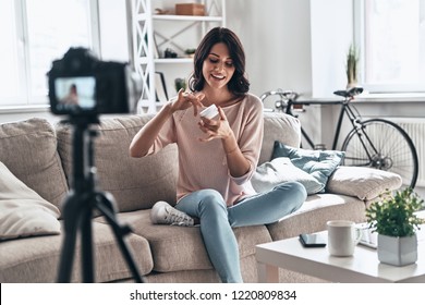 Smoothing Cream Review. Beautiful Young Woman Testing Beauty Product And Smiling While Making Social Media Video               