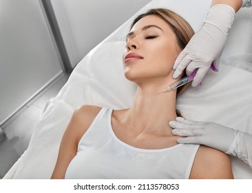 Smoothing female neck skin with injections in neck at cosmetic clinic. Neck skin rejuvenation and contouring, mesotherapy and biorevitalization