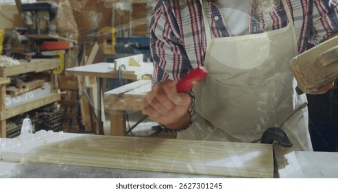 Smoothing mature carpenter shaping slatted wooden panel at workshop, with red-handled tool. Craftsman, woodworking, craftsmanship, carpentry, workshop, furniture, artisanal