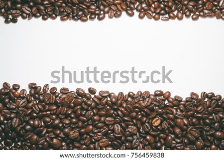 smoothly laid aromatic brown coffee beans top and bottom on a white background