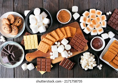 Smores Buffet Table Scene. Roasted Marshmallows, Crackers, Chocolate And A Variety Of Ingredients. Overhead View On A Dark Wood Background.