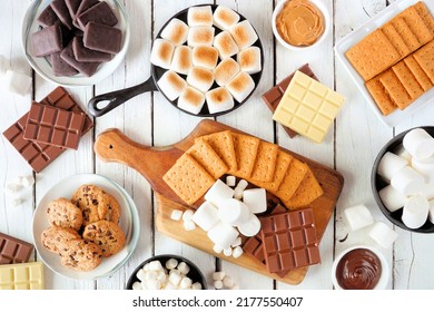 Smores Buffet Table Scene. Roasted Marshmallows, Crackers, Chocolate And A Variety Of Ingredients. Above View Over A White Wood Background.