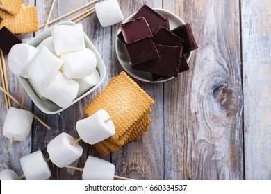 Smores Dessert Ingredients On Wooden Table. Picnic Or Camp Concept. Space For Text