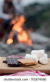 Smores Ingredients At A Beach Bonfire With Chocolate, Marshmellow, And Graham Crackers With Room For Copy