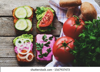 Smorgasbord. Open Sandwiches With Different Toppings On The Dark Wooden Table. Healthy Food. Diet.