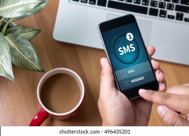 SMS Messaging Communication Notification Alert Reminder  sms Thoughtful male person looking to the digital phone screen,Silhouette top computer and hand - Shutterstock ID 496435201