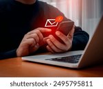 SMS spam, fake text message phishing from scammer concept. System hacked red warning alert, email hack, scam malware spreading virus on message alert virtual on mobile phone screen in person hand.