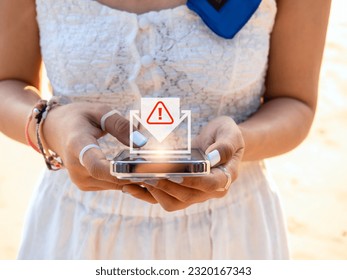 SMS spam and fake text message phishing concept. System hacked warning alert, email hack, scam malware spreading virus on message alert virtual on mobile smart phone screen in woman's hands. - Shutterstock ID 2320167343