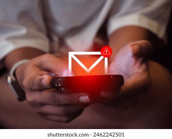 SMS spam and fake text message phishing from scammer concept. System hacked warning alert, email hack, scam malware spreading virus on message alert virtual on mobile phone screen in woman's hands.