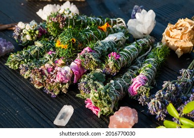 Smudge Sticks And Crystals On A Black Wooden Table