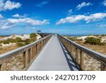 Smyrna Dunes Park with elevated boardwalk and fishing pier in New Smyrna Beach, Florida.