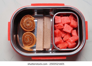 Snack box for kids, with vegetable rolls, waffles and watermelon fruit, balance diet concept - Powered by Shutterstock