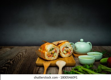 Snack at break time. Famous Vietnamese food is Banh mi thit and hot tea, popular street food from bread stuffed with raw material: pork, ham, pate, egg and fresh herbs.Typical Vietnamese sandwich