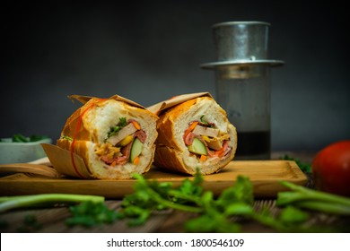 Snack at break time. Famous Vietnamese food is Banh mi thit and black coffee, popular street food from bread stuffed with raw material: pork, ham, pate, egg and fresh herbs.Typical Vietnamese sandwich