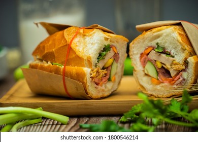 Snack at break time. Famous Vietnamese food is Banh mi thit and black coffee, popular street food from bread stuffed with raw material: pork, ham, pate, egg and fresh herbs.Typical Vietnamese sandwich