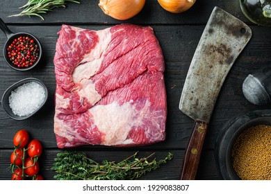 Snack cross cut, raw beef brisket meat set,with ingredients for smoking making barbecue, pastrami, cure, on black wooden table background
