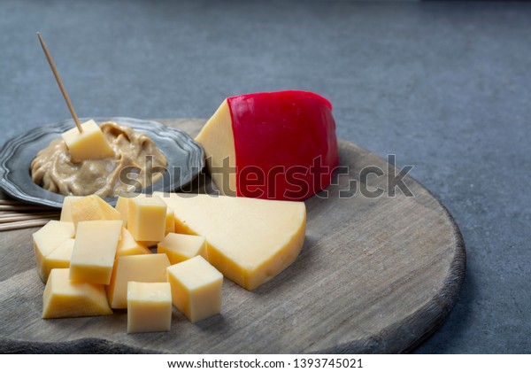 Snack food, blocks of Dutch red ball Edam cheese
and mustard