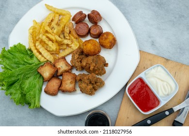 Snack Frenchfries  friedchicken grilled fish cake sausage with sauce and mayonase