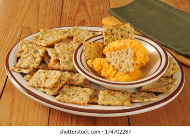 A Snack Plate Of Italian Herb Flatbread Crackers And Cheddar Cheese Spread