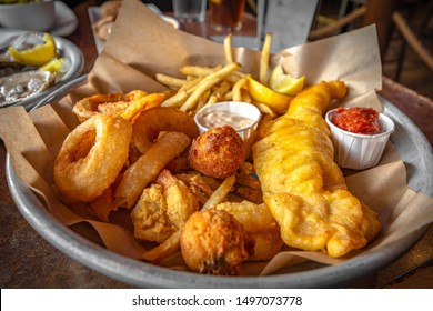 Snack Sampler, French Fries,Fried Onion,Cheese Bite And Fried Chicken Tender With Ketchup And Homemade Dipping Sauce.