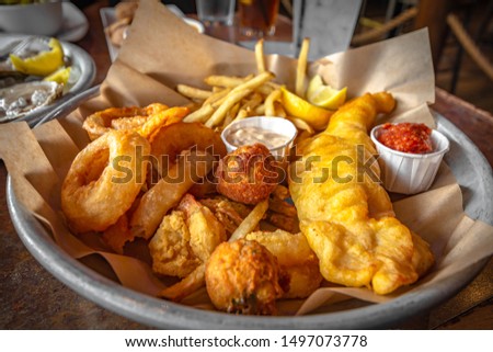 Snack Sampler, French fries,Fried onion,Cheese bite and Fried chicken tender with ketchup and homemade dipping sauce.