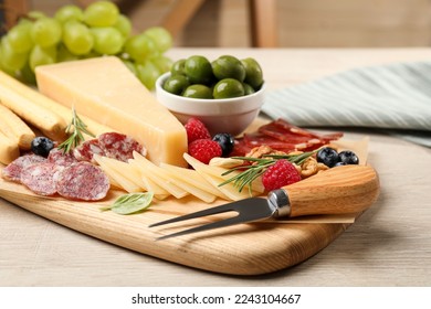 Snack set with delicious Parmesan cheese on light wooden table - Powered by Shutterstock