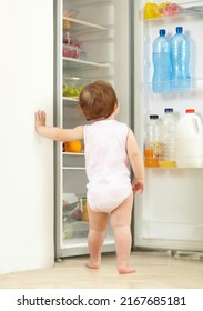 Snack Time. Shot Of A Toddler Eating Food From The Fridge.