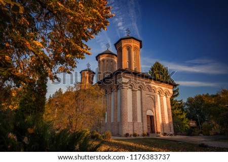 Snagov Monastery in a beautiful autumn landscape at sunset