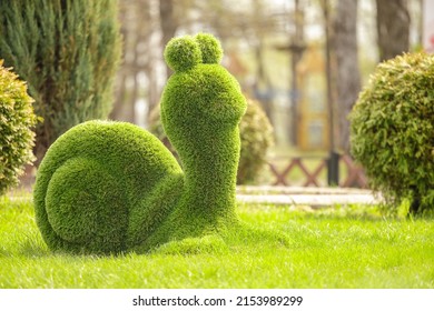 Snail created from bushes at green animals. Topiary tree - Shutterstock ID 2153989299