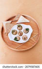 snails in Burgundy in a caf on the table