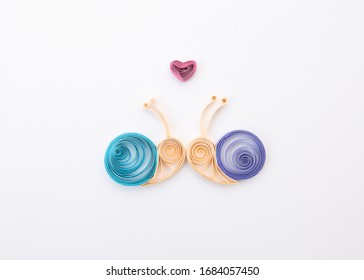 Snails in love. Hand made of paper quilling technique.