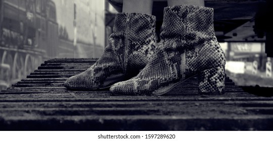 Snake Skin Boots On A Tractor Rail