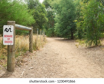 A Snake Warning Sign By A Dirt Path Along The Banks Of The Yarra River In Hawthorn, Melbourne, Australia