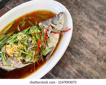 The Snapper (bass) Is Cooked By Steaming With Soy Sauce Serve On White Dish. Thai-Chinese Food Style Shot From Top View. Steamed Fish Menu. It Has A Delicious Salty And Sweet Taste. Copy Space.