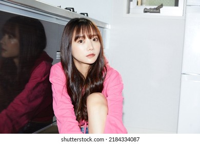 Snapshot Of Young Asian Woman Taken Indoors