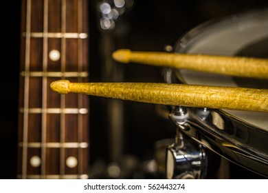 Snare Drum With Drumsticks And Bass Guitar, Closeup, Concept Musical Composition And Creativity