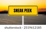 Sneak peek message written on yellow sign with blurry lake background. Conceptual sneak peek symbol. Copy space.