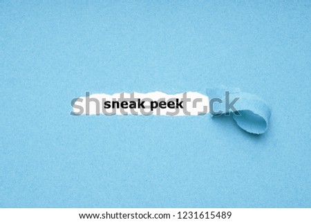 sneak peek text revealed by peeling off torn blue paper background - abstract preview concept