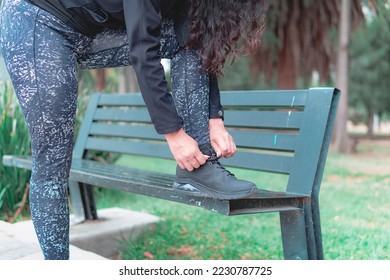 Sneakers. close up of a woman tying shoelaces. Women's sneaker ready for outdoor running in the park or forest. - Shutterstock ID 2230787725