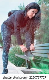 Sneakers. close up of a woman tying shoelaces. Women's sneaker ready for outdoor running in the park or forest. - Shutterstock ID 2230787727