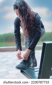 Sneakers. close up of a woman tying shoelaces. Women's sneaker ready for outdoor running in the park or forest. - Shutterstock ID 2230787733
