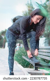 Sneakers. close up of a woman tying shoelaces. Women's sneaker ready for outdoor running in the park or forest. - Shutterstock ID 2230787735