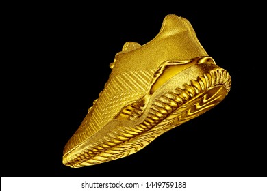 Sneakers. Golden sneaker on black background