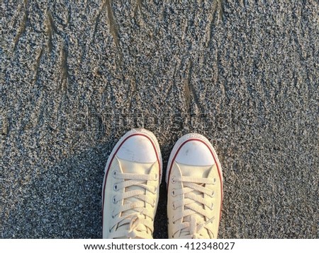 sneakers on beach sand in summer day