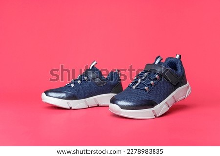 Sneakers on a pink background. There is space for text.