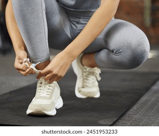 Sneakers, shoelaces and tying for fitness, gym and workout start for health and wellness. Athlete, cardio and warmup for muscle performance, sneakers and training with exercise routine and yoga mat - Powered by Shutterstock